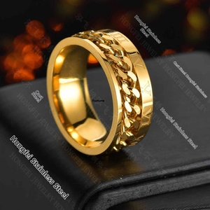 Macro shot of rotatable gold chain ring with engraved Roman numerals on stainless steel