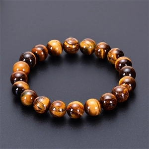 Close-up of golden brown tiger eye stone beads with natural chatoyant cat-eye texture