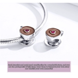 Macro detail of S925 silver coffee cup charm with red heart gem and enamel for bracelets
