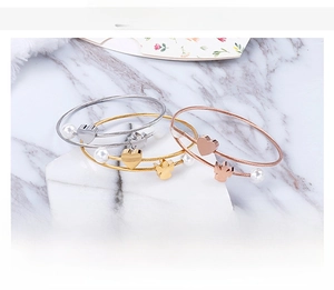 Detailed shot of three-color stainless steel wire bracelets with heart and angel charms