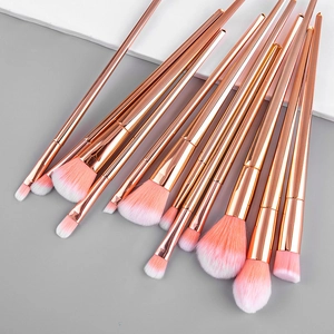 12-piece rose gold makeup brush set with pink gradient bristles for foundation and eyes