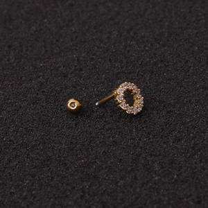 Golden stainless steel round stud earring with sparkling zircon on a black background
