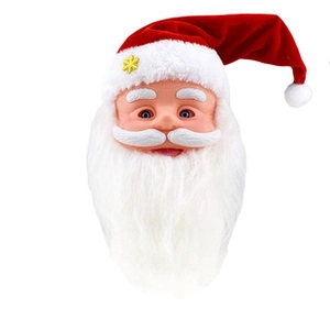 Close-up of Santa Claus wind-up toy with red hat, white beard and yellow snowflake detail