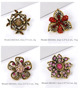 Detailed comparison of vintage gold-tone brooches with amber and pink crystal rhinestones