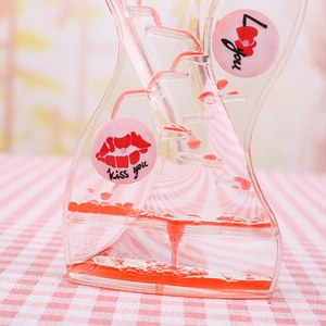 Close-up of red liquid oil motion timer with heart prints and cascading flow effect