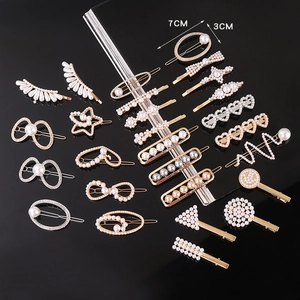 Detailed view of pearl hair clips in gold and silver showing heart and star shapes