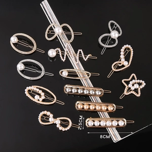 Detail view of handmade pearl hair clips with rhinestone accents in various geometric shapes