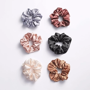Set of 6 glossy satin hair scrunchies in neutral colors arranged on white background