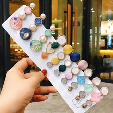 Detailed set of colorful hair clips with pearls and hearts on display cards