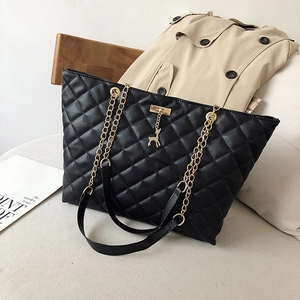 Quilted diamond pattern black tote bag with gold chain strap and deer pendant detail