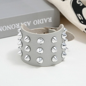 Detail showing grey faux leather cuff with three rows of silver metal cone rivets