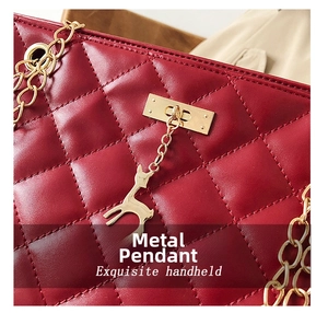 Detail of red quilted shoulder bag with golden deer charm and chain strap