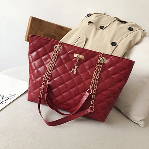 Deep red quilted leather tote bag with gold deer charm and chain shoulder strap
