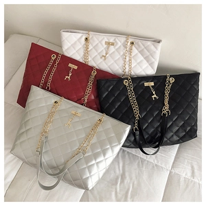 Detailed stack of quilted tote bags in white, burgundy, black, and silver finishes