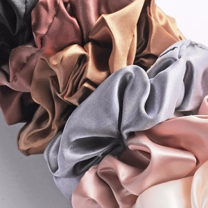 Detailed view of high-quality silk satin scrunchies in Morandi earth tones with soft luster