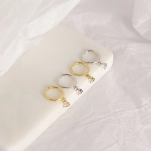 Detailed macro view of S925 sterling silver geometric hoop earrings in gold and silver