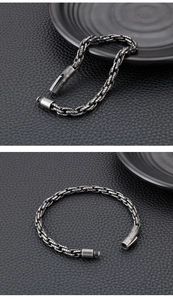 Detailed close-up of retro silver stainless steel woven chain bracelet for men