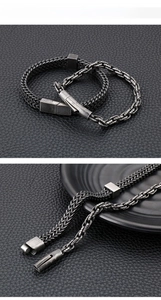Macro detail of men's vintage wheat chain bracelet with a magnetic steel clasp