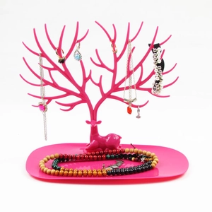 Rose red deer antler jewelry stand for necklaces and earrings on a white background