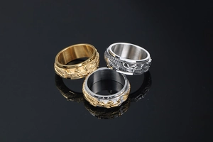 Detailed close-up of rotatable stainless steel rings with embossed dragon texture