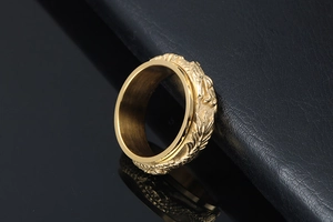 Detailed macro view of rotatable gold-plated ring featuring 3D dragon relief patterns
