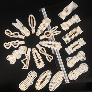 Detailed view of artificial pearl hair clip set with various geometric shapes on gold metal