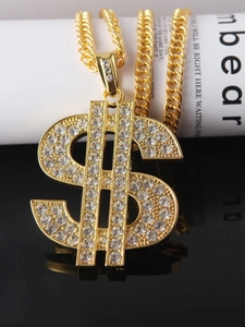 Macro shot of gold-plated hip hop dollar sign pendant with rhinestones on Cuban chain