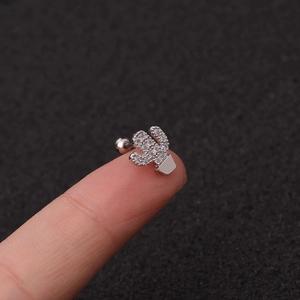 Silver cactus stud earring with inlaid cubic zirconia shown on a fingertip