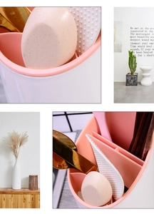 Detail view of pink and white plastic utensil holder with multiple compartments for storage