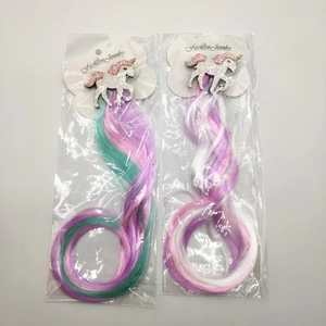 Detail of unicorn hair clips with long rainbow synthetic hair extensions for girls