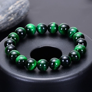 Natural green tiger eye beaded bracelet displayed on a premium matte black stand