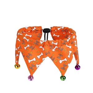 Detail of Halloween pet collar with orange candy corn print and colorful jingling bells