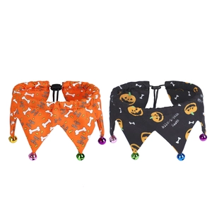 Close-up of Halloween pet collars with bells featuring pumpkin and bone patterns