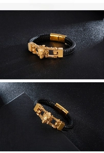 Detailed view of the woven black leather texture and the golden lion head magnetic clasp