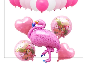 Detail of pink flamingo foil balloon set with heart shapes and tropical leaf patterns