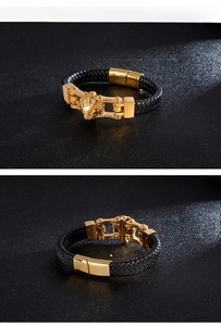Detail of men's black woven leather bracelet featuring a gold lion head and magnetic clasp