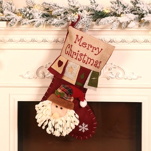 Red linen Christmas stocking with 3D Santa and Merry Christmas print hanging on fireplace