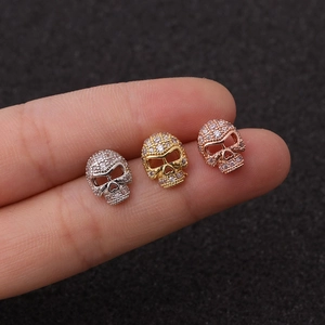 Skull stud earrings set in silver, gold, and rose gold finishes with zircon stones
