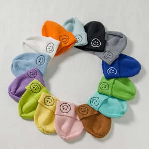 Kids knitted beanie hats in multiple colors featuring cute smiley face embroidery
