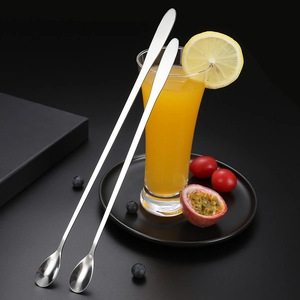 Polished stainless steel long handle mixing spoon set in a dark beverage scene