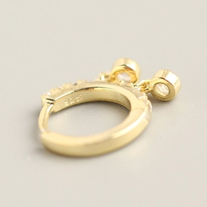 Macro shot of gold-plated S925 sterling silver earring with engraved 925 hallmark
