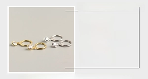 Detail view of S925 sterling silver hoop earrings with round cubic zirconia pendants