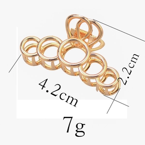 Detailed size view of a 4.2cm golden geometric metal hair claw with round ring design