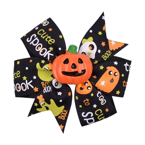 Detail of Halloween hair bow with orange pumpkin center and too cute spook text prints