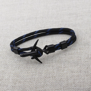Macro view of blue and black braided paracord bracelet with black airplane metal buckle