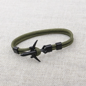 Detail of military green paracord bracelet featuring a black metal airplane buckle closure