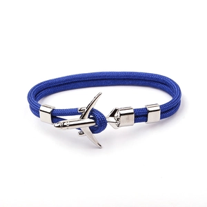 Detail of blue polyester rope bracelet featuring a silver airplane metal charm