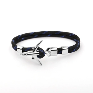 Detail of black braided polyester cord bracelet with silver airplane buckle closure