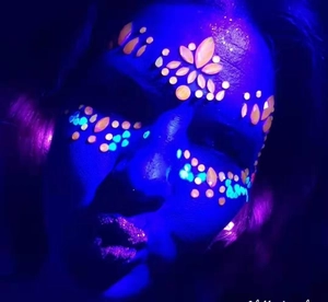 Luminous face jewels glowing in UV light for music festivals and Halloween party makeup