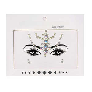 Detailed view of iridescent face crystal stickers with symmetrical rhinestones on white card